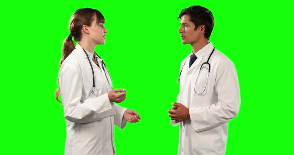 Side view of doctors discussing with green screen