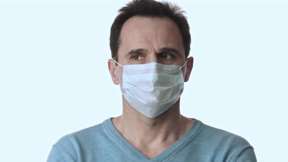 Man Looks Around, Removes Medical Face Mask. Coronavirus Pandemic Quarantine