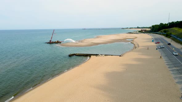 Dredging Pere Marquette beach to fill in a new shoreline.