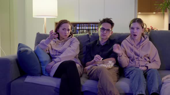 Family of One Parent Son and Daughter Watching TV