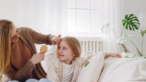 Closeup Portrait Young Blonde Woman in Glasses Caring Mother Loving Mom Sits with Beloved Daughter