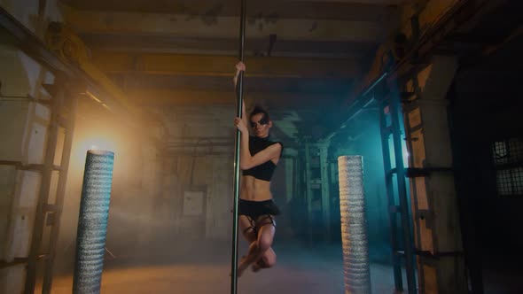 Close Up Of A Dancer With Black Makeup In Leather Underwear, A Girl Rotates On A Pole.