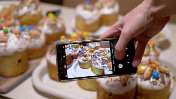 Female Hands Taking Pictures of Easter Cakes on the Table