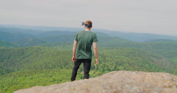 The tourist is standing on top of the rock The Krasnoyarsk Pillars