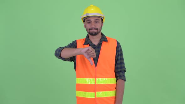 Stressed Young Bearded Persian Man Construction Worker Giving Thumbs Down