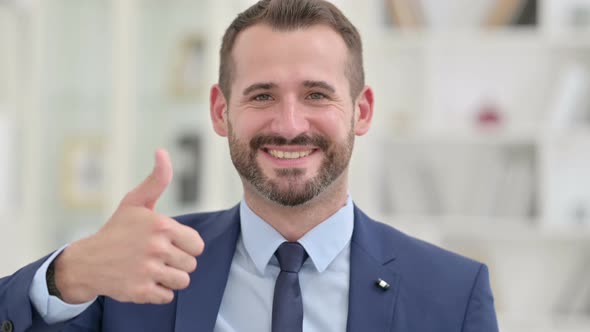 Portrait of Excited Businessman with Thumbs Up