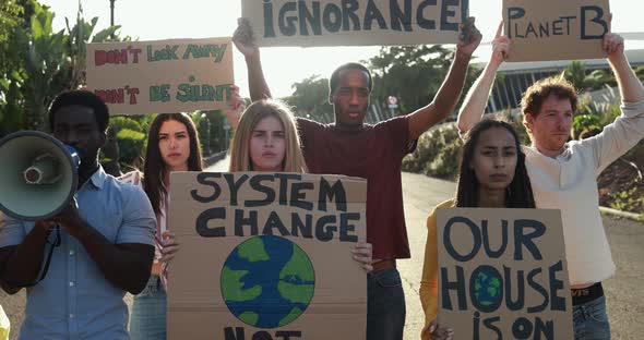 Young group of demonstrators on road from different culture and race protest for climate change