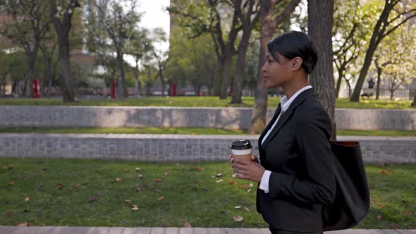 Mixed ethnicity business woman walking