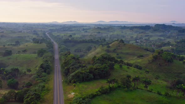 Samana Highway cutting through stunning green landscape, Dominican Republic, drone
