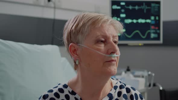 Close Up of Aged Woman Sitting in Bed with Heart Rate Monitor