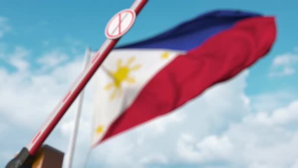 Barrier with No Immigration Sign Closed at Flag of the Philippines