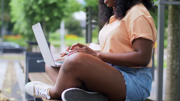 African Student Girl with Laptop in City