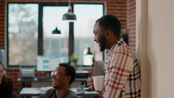 African American Man Laughing and Talking to Job Colleagues