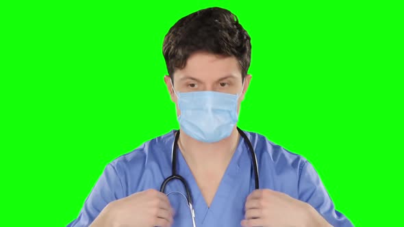 Doctor Puts on Stethoscope. Green Screen