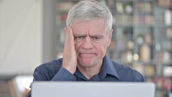 Portrait of Man Having Headache While Working on Laptop