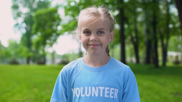 Caucasian Child Volunteer Smiling on Camera