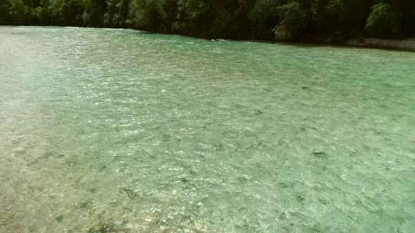 Aerial view of turquoise water going down the river at Soca river, Slovenia.