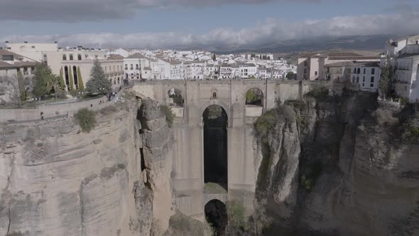 Aerial ascends over Ronda Spain and medieval arch bridge over gorge