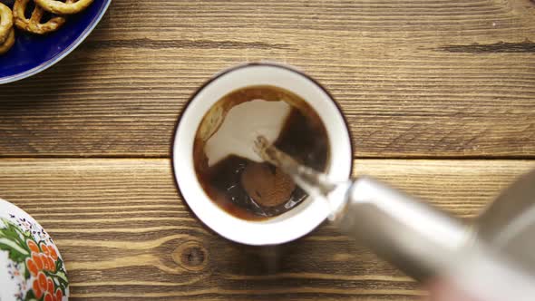 Hot Water Poured Into White Cup with Instant Coffee.