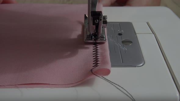 Sewing machine with fabric and thread, closeup.