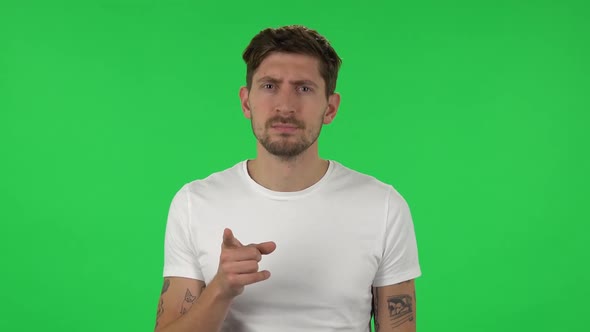 Portrait of Confident Guy Is Scolding, Shaking His Index Finger. Green Screen