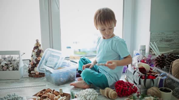 A Girl and a Child Collect a Christmas Wreath Together