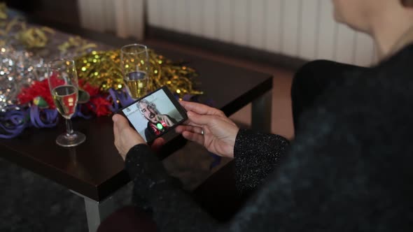 Senior Woman Having a Video Call with Young Man on Mobile Phone