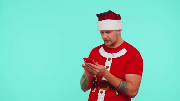 Man in Red Christmas Tshirt Use Mobile Phone Typing Browsing Loses Surprised Sudden Lottery Results