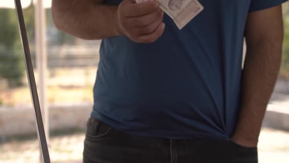 Icecream Seller Puts Banknotes Into Pocket and Gives Change