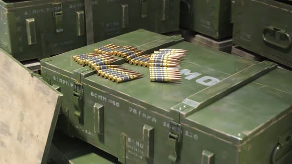 Closeup view at the rifle ammo and huge stack of military boxes in warehouse.