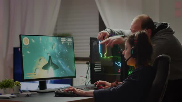 Man Gamer Teaching His Girlfriend Playing Space Shooter Video Game
