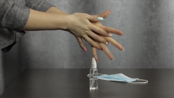 Woman Using Bottle of Liquid Alcohol Spray Sanitizer with Hands. Coronavirus