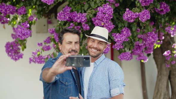 Slow Motion of Happy Gay Couple Doing Selfie on Phone in Park