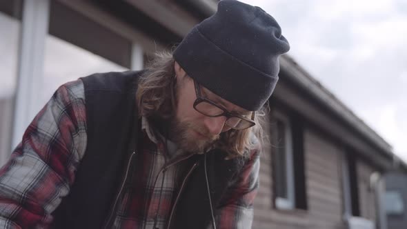 Carpenter Working Outdoors Using Spirit Level