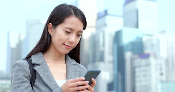 Business woman use of smart phone in city 