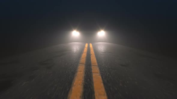 Car Headlights Pursuiting Camera on a Night Road