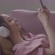 Young Woman Listening To Music On Headphones And Using Smartphone - VideoHive Item for Sale