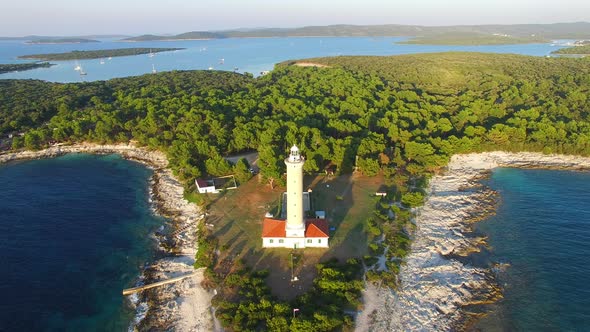 Aerial view of lighthouse, Croatia on forested shore