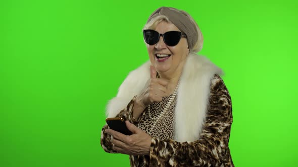 Elderly Caucasian Grandmother Woman Using Smartphone for Shopping. Chroma Key