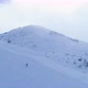 Side Aerial Over Winter Snowy Mountain Ski Track Field with Mountaineering Skier People Walking Up - VideoHive Item for Sale