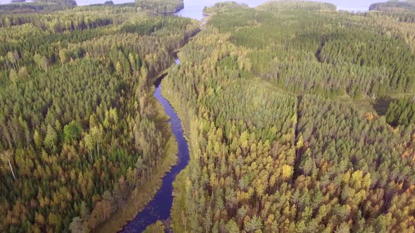 Amazing drone video of a beautiful river leading to big lake in the borealis wilderness. Camera tilt