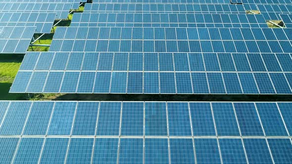 Aerial View of Solar Panels Farm (Solar Cell) with Sunlight. Drone Flight Over Solar Panels Field