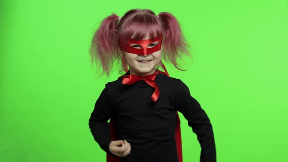 Funny Child Girl in Costume and Mask Plays Super Hero. National Superhero Day