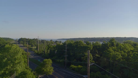 Pedestal Up of an Empty Street Amongst Trees and Aerial View of Port Washington