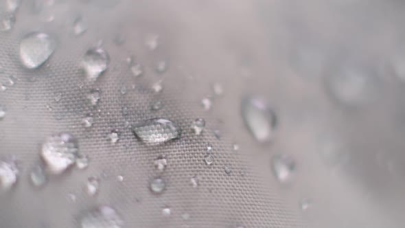 Slow Motion Shot of Water Splashing on Waterproof Fabric