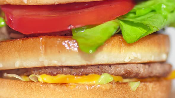 Extreme Closeup Rotating Shot Appetizing Burger with Grilled Beef Cutlet Tomato Cheese and Lettuce