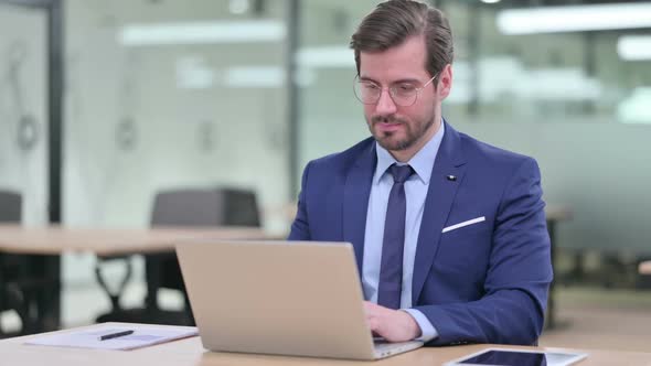 Professional Young Businessman Working on Laptop