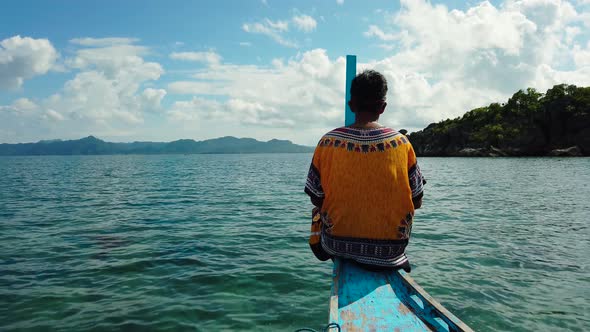 The Man at the Front of the Boat Looks at the Landscape.