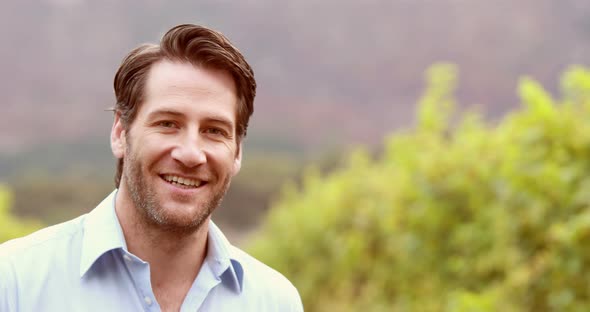 Young Winegrower Looking and Smelling Wine