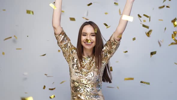 Celebration. Happy Woman Dancing With Confetti On White